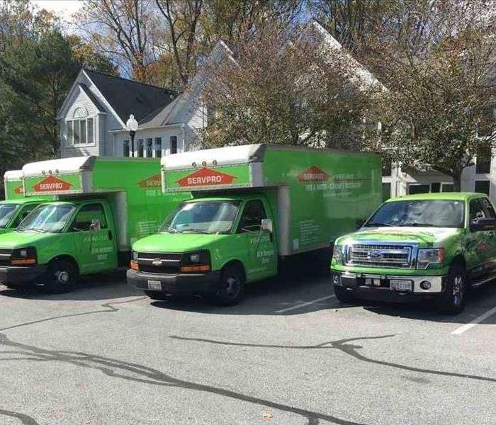 SERVPRO vehicles parked in front of a home